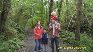 Family in the woods. Home educate your bilingual child