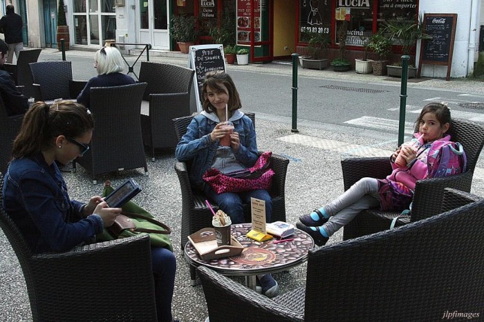 Three girls at an outdoor cafe in Bordeaux